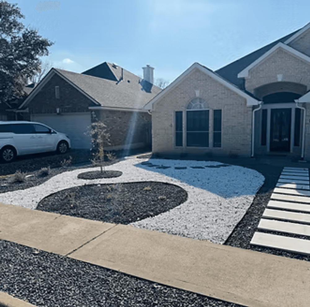 Modern landscaping design with gravel, stone pathway, and a minimalist garden in front of a house.